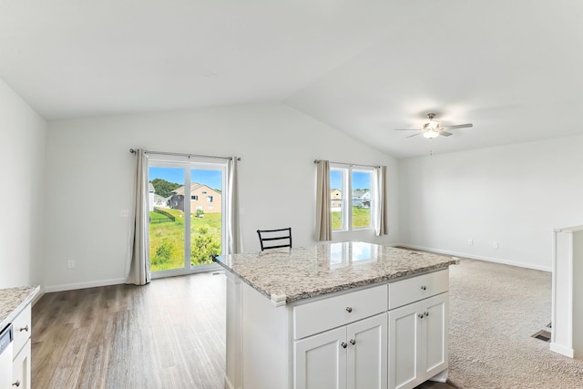 39685 Fallbrook Ave, North Branch, MN 55056 - kitchen with a ceiling fan, lofted ceiling, open floor plan, white cabinets, and light stone countertops