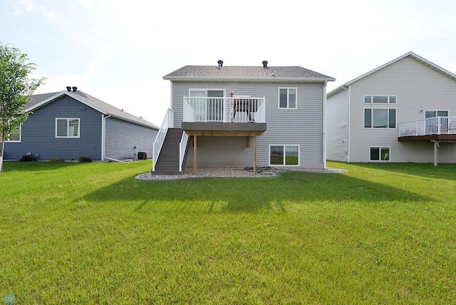 8037 Goldfinch Dr, Horace, ND 58047 - rear view of property with stairway, a lawn, and a wooden deck