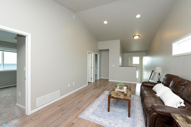 8037 Goldfinch Dr, Horace, ND 58047 - living room with high vaulted ceiling, light wood-style floors, and recessed lighting