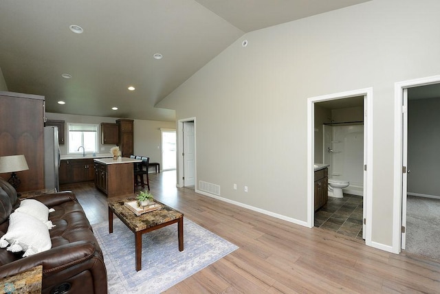 8037 Goldfinch Dr, Horace, ND 58047 - living area featuring light wood-style flooring, high vaulted ceiling, and recessed lighting