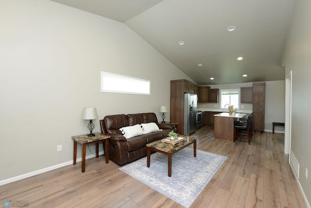 8037 Goldfinch Dr, Horace, ND 58047 - living area with vaulted ceiling, light wood finished floors, and recessed lighting