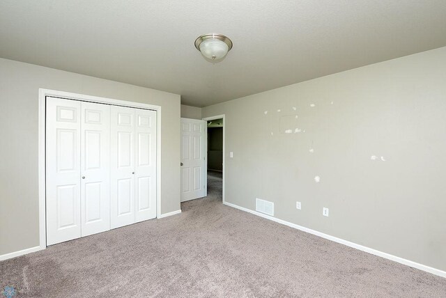 8037 Goldfinch Dr, Horace, ND 58047 - unfurnished bedroom featuring carpet and a closet