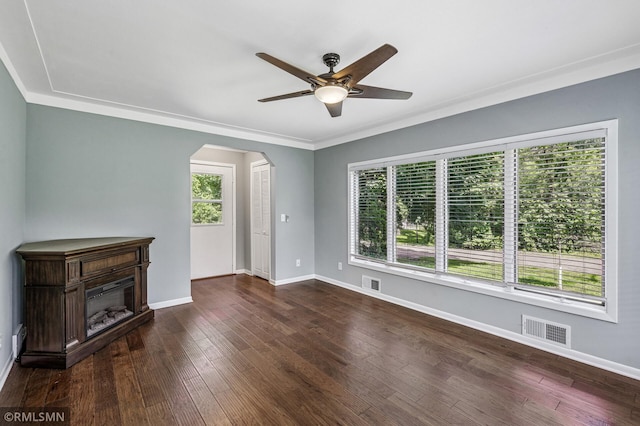 3308 Chippewa Rd, Minnetonka, MN 55305 - unfurnished living room featuring arched walkways, ceiling fan, dark wood-style flooring, a glass covered fireplace, and ornamental molding