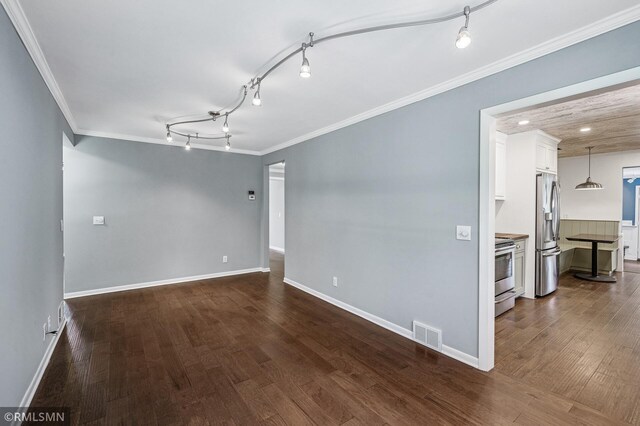 3308 Chippewa Rd, Minnetonka, MN 55305 - empty room featuring ornamental molding, dark wood-type flooring, and rail lighting