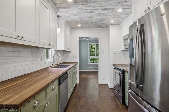 3308 Chippewa Rd, Minnetonka, MN 55305 - kitchen featuring stainless steel appliances, butcher block counters, green cabinets, white cabinetry, and decorative backsplash