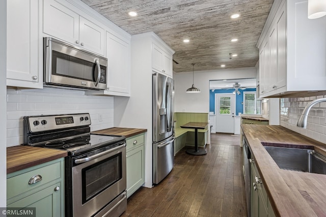 3308 Chippewa Rd, Minnetonka, MN 55305 - kitchen featuring butcher block counters, stainless steel appliances, a ceiling fan, green cabinets, and recessed lighting