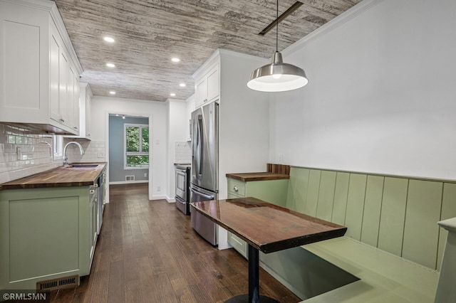 3308 Chippewa Rd, Minnetonka, MN 55305 - kitchen with wood counters, white cabinetry, appliances with stainless steel finishes, dark wood finished floors, and recessed lighting
