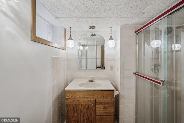 3308 Chippewa Rd, Minnetonka, MN 55305 - bathroom with tile walls, vanity, and a stall shower