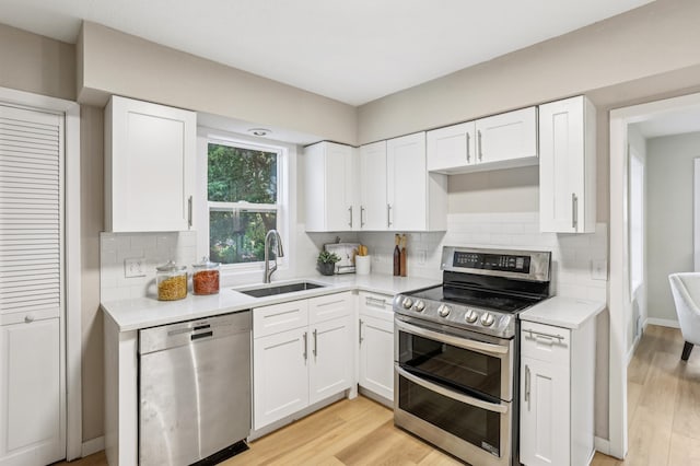 5912 Bartlett Blvd, Mound, MN 55364 - kitchen with stainless steel appliances, light countertops, white cabinetry, and tasteful backsplash