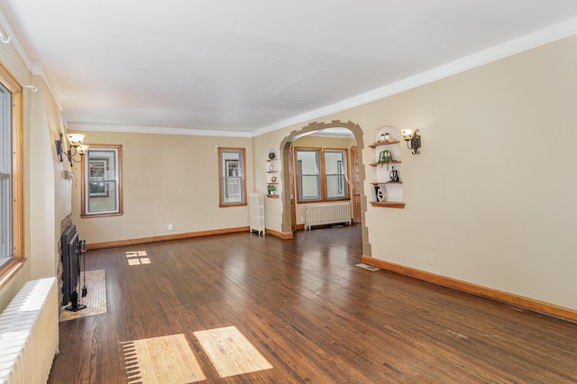 4340 Oakland Ave, Minneapolis, MN 55407 - unfurnished room with radiator, arched walkways, crown molding, and wood finished floors