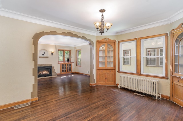 4340 Oakland Ave, Minneapolis, MN 55407 - unfurnished living room featuring radiator heating unit, a chandelier, arched walkways, dark wood-type flooring, and crown molding