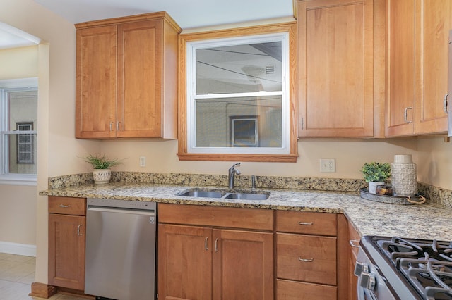 4340 Oakland Ave, Minneapolis, MN 55407 - kitchen with stainless steel appliances, light stone counters, brown cabinets, and tile patterned floors