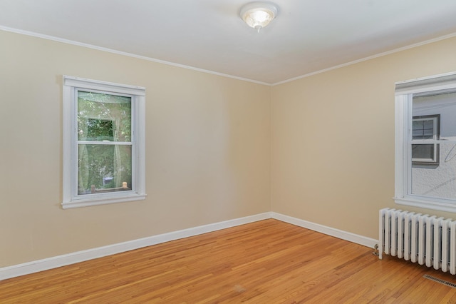4340 Oakland Ave, Minneapolis, MN 55407 - unfurnished room with radiator, light wood-type flooring, and crown molding