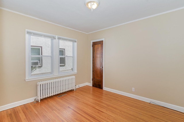 4340 Oakland Ave, Minneapolis, MN 55407 - spare room featuring radiator, light wood-style floors, and crown molding