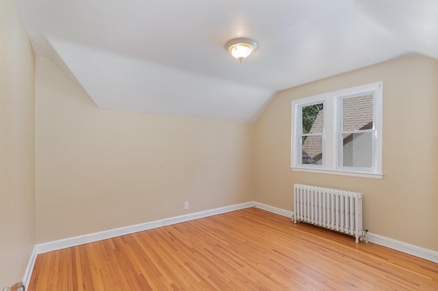 4340 Oakland Ave, Minneapolis, MN 55407 - additional living space with radiator, vaulted ceiling, and light wood-style flooring