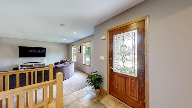 1404 8th St NW, Kasson, MN 55944 - foyer featuring light tile patterned flooring, light colored carpet, and recessed lighting