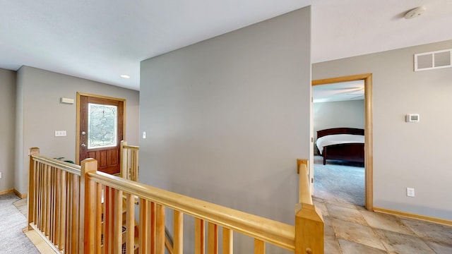 1404 8th St NW, Kasson, MN 55944 - hallway with an upstairs landing, light carpet, recessed lighting, and light stone finish floors
