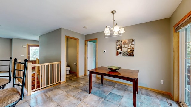 1404 8th St NW, Kasson, MN 55944 - dining space featuring a chandelier and stone finish floors