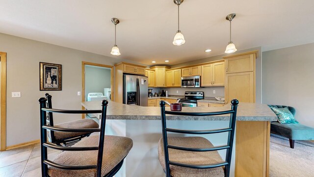 1404 8th St NW, Kasson, MN 55944 - kitchen featuring stainless steel appliances, light brown cabinets, a breakfast bar, light countertops, and recessed lighting