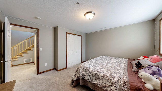 1404 8th St NW, Kasson, MN 55944 - bedroom with light carpet, a closet, and a textured ceiling