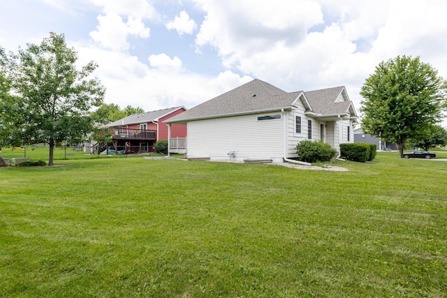 1404 8th St NW, Kasson, MN 55944 - view of side of property featuring a lawn, a deck, and a shingled roof