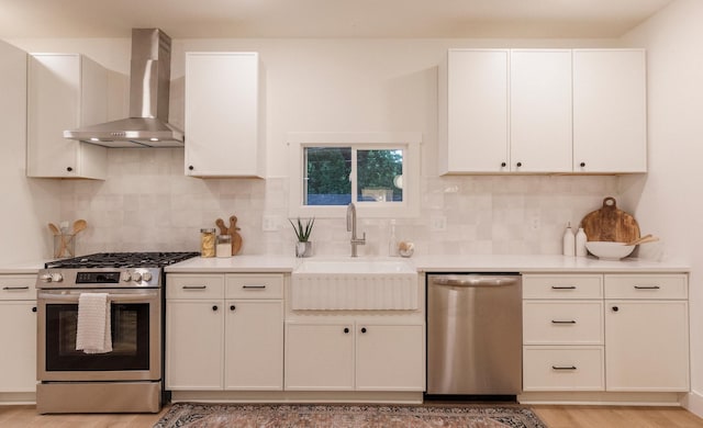 212 Diamond Lake Rd, Minneapolis, MN 55419 - kitchen with stainless steel appliances, wall chimney exhaust hood, light wood-style floors, light countertops, and backsplash