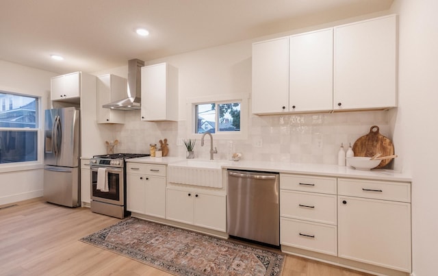 212 Diamond Lake Rd, Minneapolis, MN 55419 - kitchen featuring stainless steel appliances, wall chimney exhaust hood, light wood-type flooring, backsplash, and recessed lighting