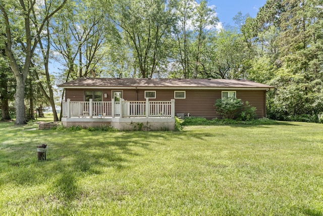 39665 8th Ave, North Branch, MN 55056 - back of house featuring a wooden deck and a lawn
