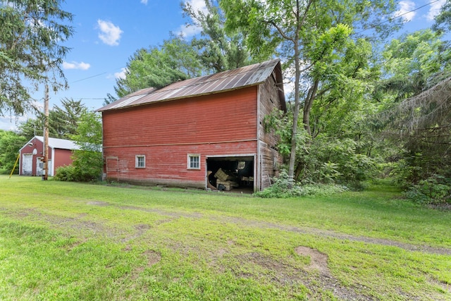 39665 8th Ave, North Branch, MN 55056 - view of property exterior with a barn, a lawn, an outdoor structure, and a garage