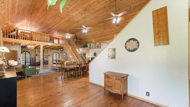 8825 Greeley Loop, Royalton Twp, MN 55006 - dining space featuring stairs, wooden ceiling, wood finished floors, a ceiling fan, and high vaulted ceiling
