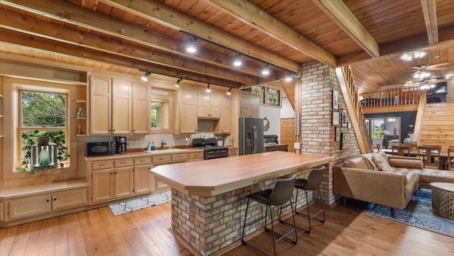 8825 Greeley Loop, Royalton Twp, MN 55006 - kitchen with black appliances, a wooden ceiling with exposed beams, light wood finished floors, wooden counters, and a breakfast bar area
