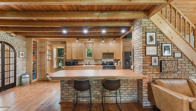 8825 Greeley Loop, Royalton Twp, MN 55006 - kitchen featuring stainless steel fridge with ice dispenser, range, light wood finished floors, a kitchen breakfast bar, and a wood ceiling with exposed beams