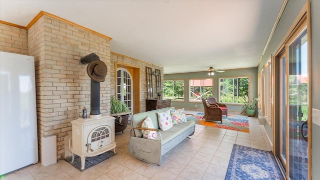 8825 Greeley Loop, Royalton Twp, MN 55006 - sunroom with tile patterned floors, brick wall, a wood stove, and ornamental molding