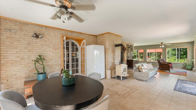 8825 Greeley Loop, Royalton Twp, MN 55006 - dining space featuring ceiling fan, brick wall, and tile patterned flooring
