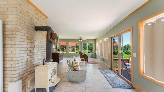 8825 Greeley Loop, Royalton Twp, MN 55006 - sunroom with tile patterned floors, a wood stove, ornamental molding, and brick wall