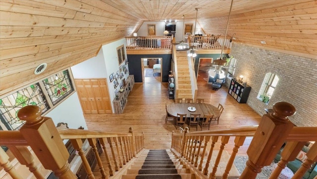 8825 Greeley Loop, Royalton Twp, MN 55006 - stairway with wood finished floors, wooden ceiling, vaulted ceiling, and wood walls