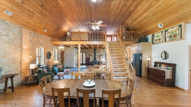 8825 Greeley Loop, Royalton Twp, MN 55006 - dining room with wooden ceiling, brick wall, light wood-type flooring, stairs, and a ceiling fan