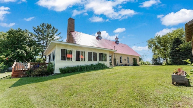 8825 Greeley Loop, Royalton Twp, MN 55006 - rear view of property with a wooden deck, a lawn, a chimney, and a metal roof