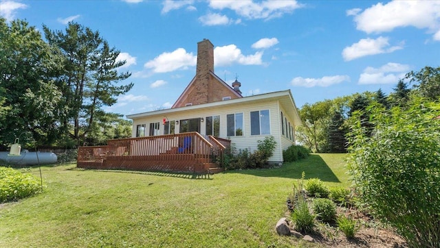 8825 Greeley Loop, Royalton Twp, MN 55006 - back of property with a wooden deck, a lawn, and a chimney