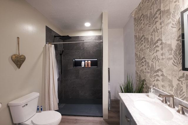 10199 330th St W, Northfield, MN 55057 - bathroom with vanity, wallpapered walls, wood finished floors, and tiled shower