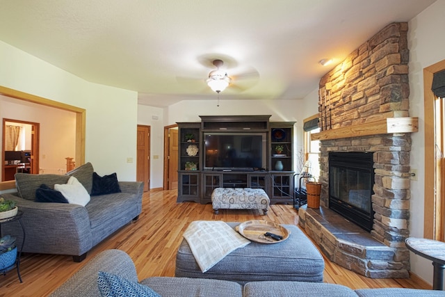 10199 330th St W, Northfield, MN 55057 - living room with a stone fireplace, wood finished floors, and ceiling fan
