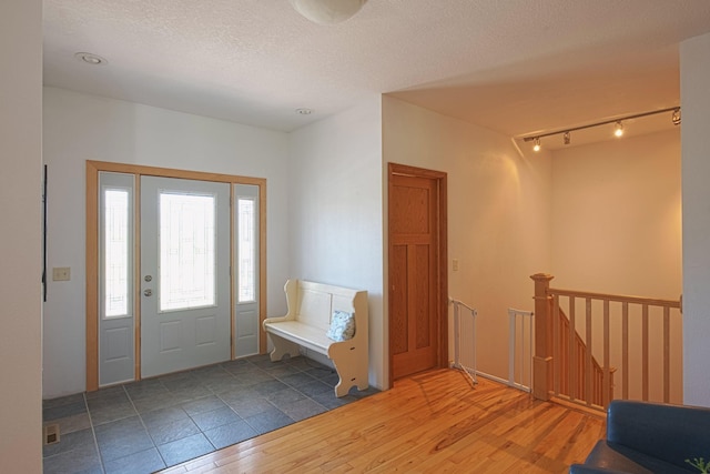 10199 330th St W, Northfield, MN 55057 - entryway with wood finished floors, rail lighting, and a textured ceiling
