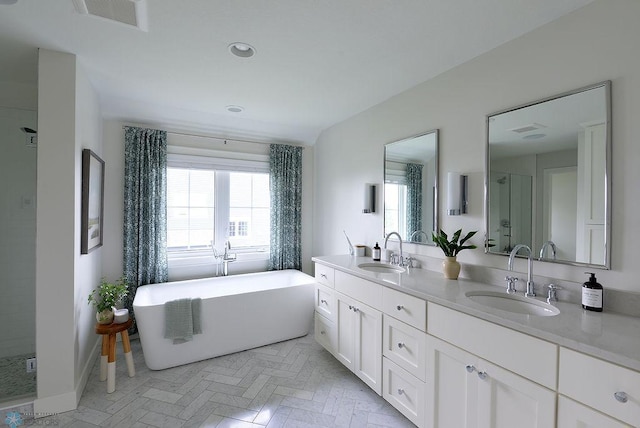 2630 2nd St E, Fargo, ND 58078 - full bathroom with double vanity, a soaking tub, a shower stall, and recessed lighting