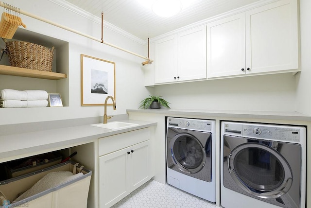 2630 2nd St E, Fargo, ND 58078 - laundry area with washing machine and clothes dryer, cabinet space, and ornamental molding