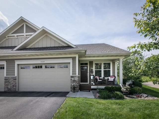 13324 Hillsboro Ave, Savage, MN 55378 - craftsman-style home featuring covered porch, stone siding, driveway, and board and batten siding