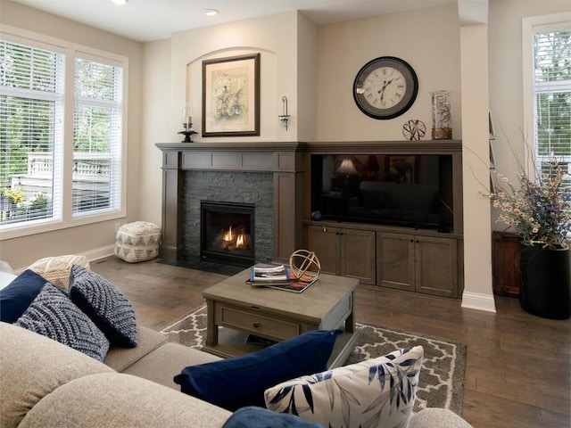 13324 Hillsboro Ave, Savage, MN 55378 - living room with dark wood-style flooring, plenty of natural light, a stone fireplace, and recessed lighting