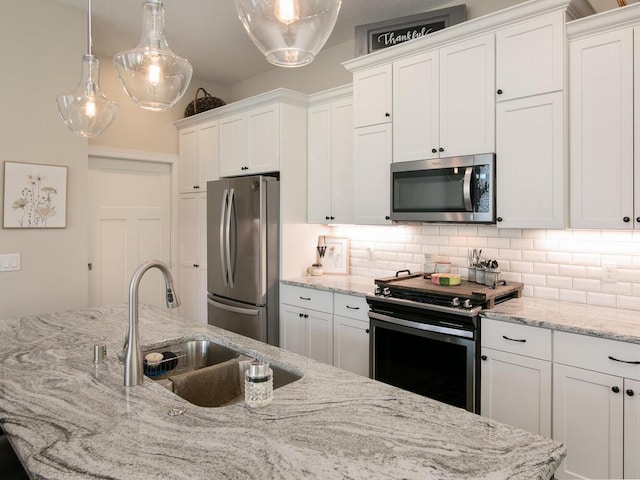 13324 Hillsboro Ave, Savage, MN 55378 - kitchen with stainless steel appliances, white cabinetry, tasteful backsplash, and hanging light fixtures