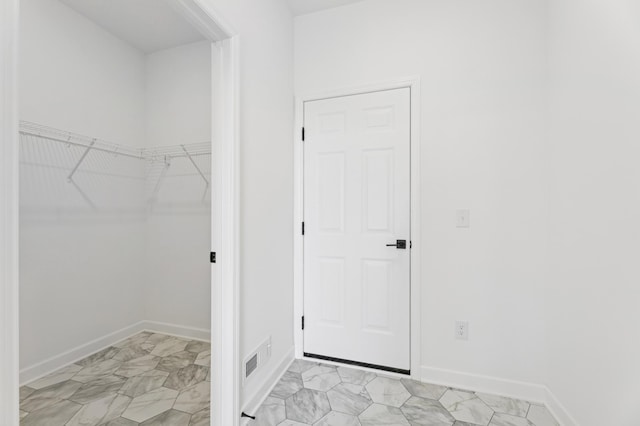9863 49th St NE, Saint Michael, MN 55376 - laundry room featuring baseboards and light marble finish floors