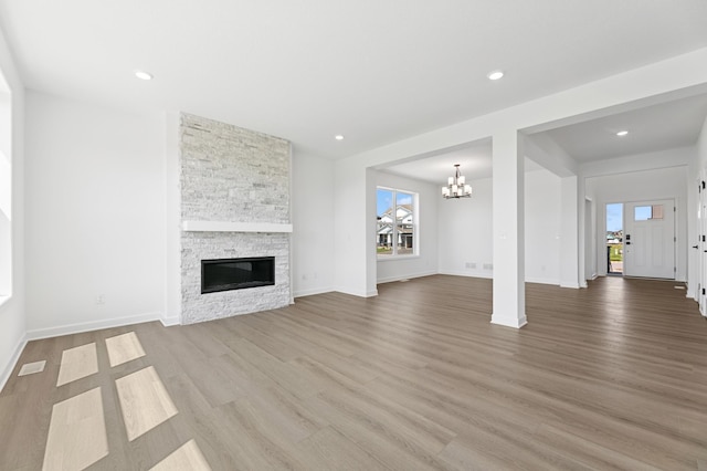 9863 49th St NE, Saint Michael, MN 55376 - unfurnished living room with a chandelier, wood finished floors, a fireplace, and recessed lighting