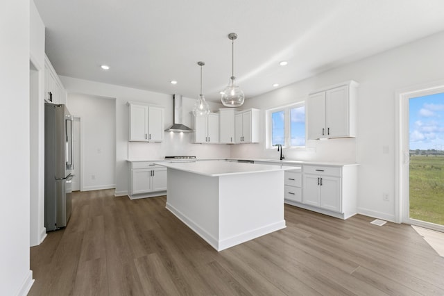 9863 49th St NE, Saint Michael, MN 55376 - kitchen featuring wood finished floors, a kitchen island, recessed lighting, freestanding refrigerator, and light countertops
